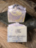 A lifestyle product photograph of "Lavender Lemongrass" Handcrafted Natural Soap by West Five Story. One bar is displayed upr