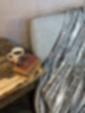 Thumbnail: “A rustic wooden table with a white mug labeled ‘D Dream,’ a stack of vintage books with reading glasses on top, and a gray u