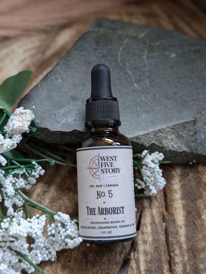 A lifestyle product photograph of "No. 5 The Arborist" by West Five Story. The 30 ml (1 fl oz) amber glass dropper bottle fea