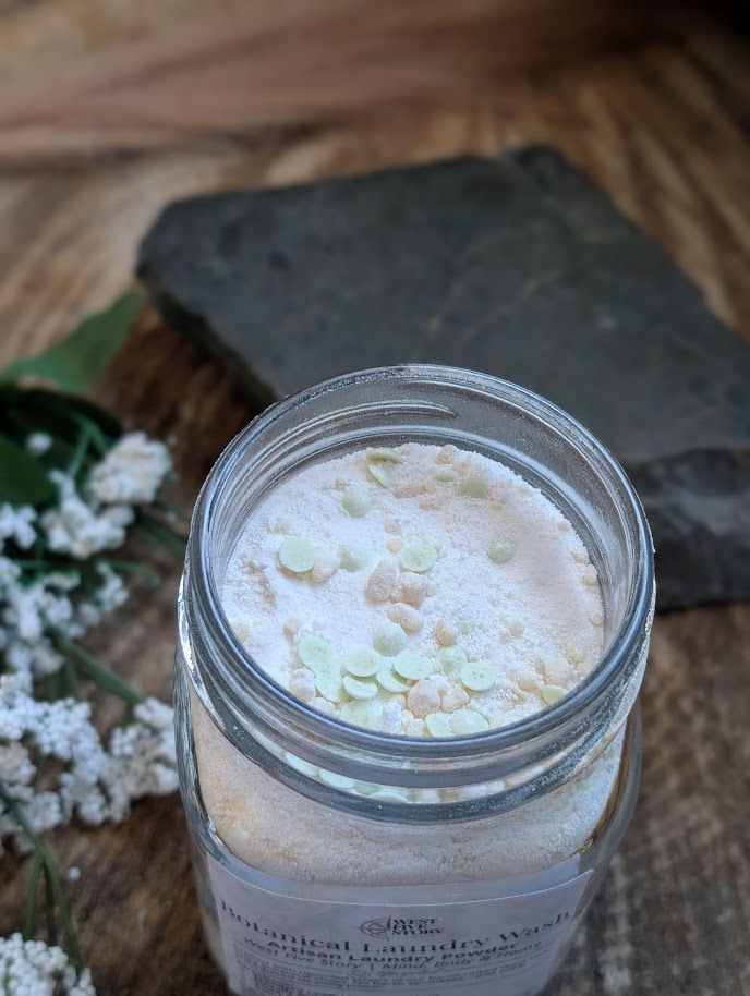 Thumbnail: A top-down view of the open Botanical Laundry Wash jar, showcasing the fine white artisan powder mixed with hand-crumbled gre