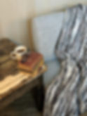 Thumbnail: “A rustic wooden table with a white mug labeled ‘D Dream,’ a stack of vintage books with reading glasses on top, and a gray u