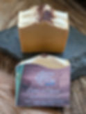 A lifestyle product photograph of "Cedar & Spice" Handcrafted Beer Soap by West Five Story. One 4 oz rectangular bar is displ