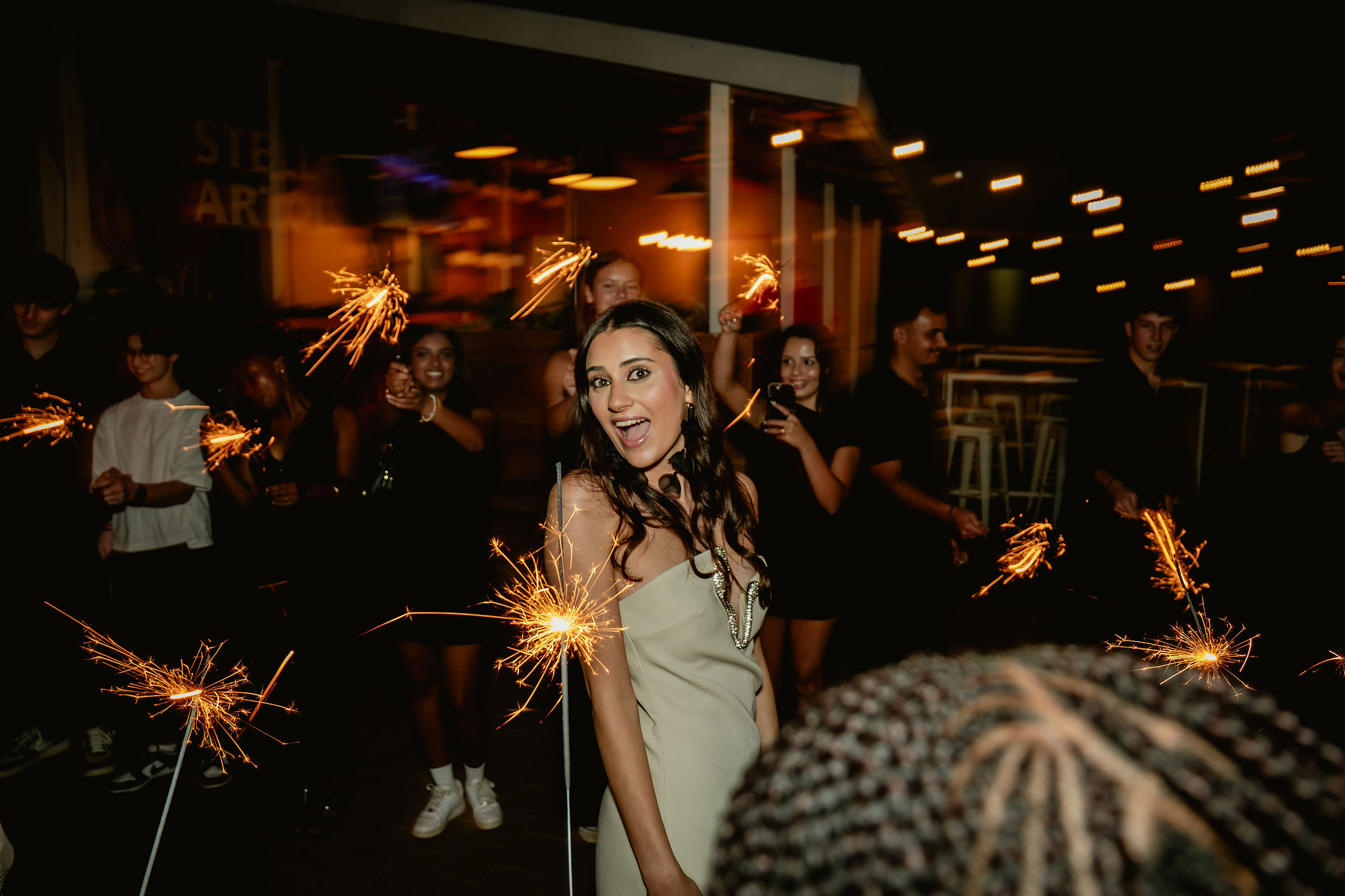 Tayla walking through an tunnel of sparklers.
