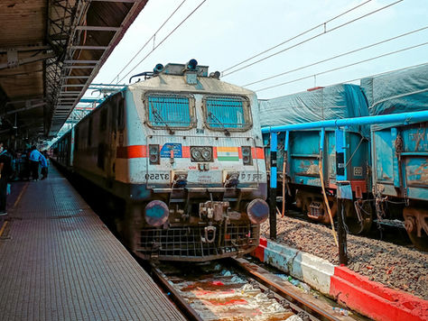 An Indian Railways train entering a station platform.