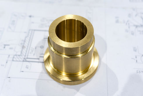 The bronze mandrel after grinding and turning lies on the technical drawing..jpg