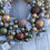 Thumbnail: Handmade Snowy Green, Gold, Brown and Burnt Orange Artificial Bauble Wreath.