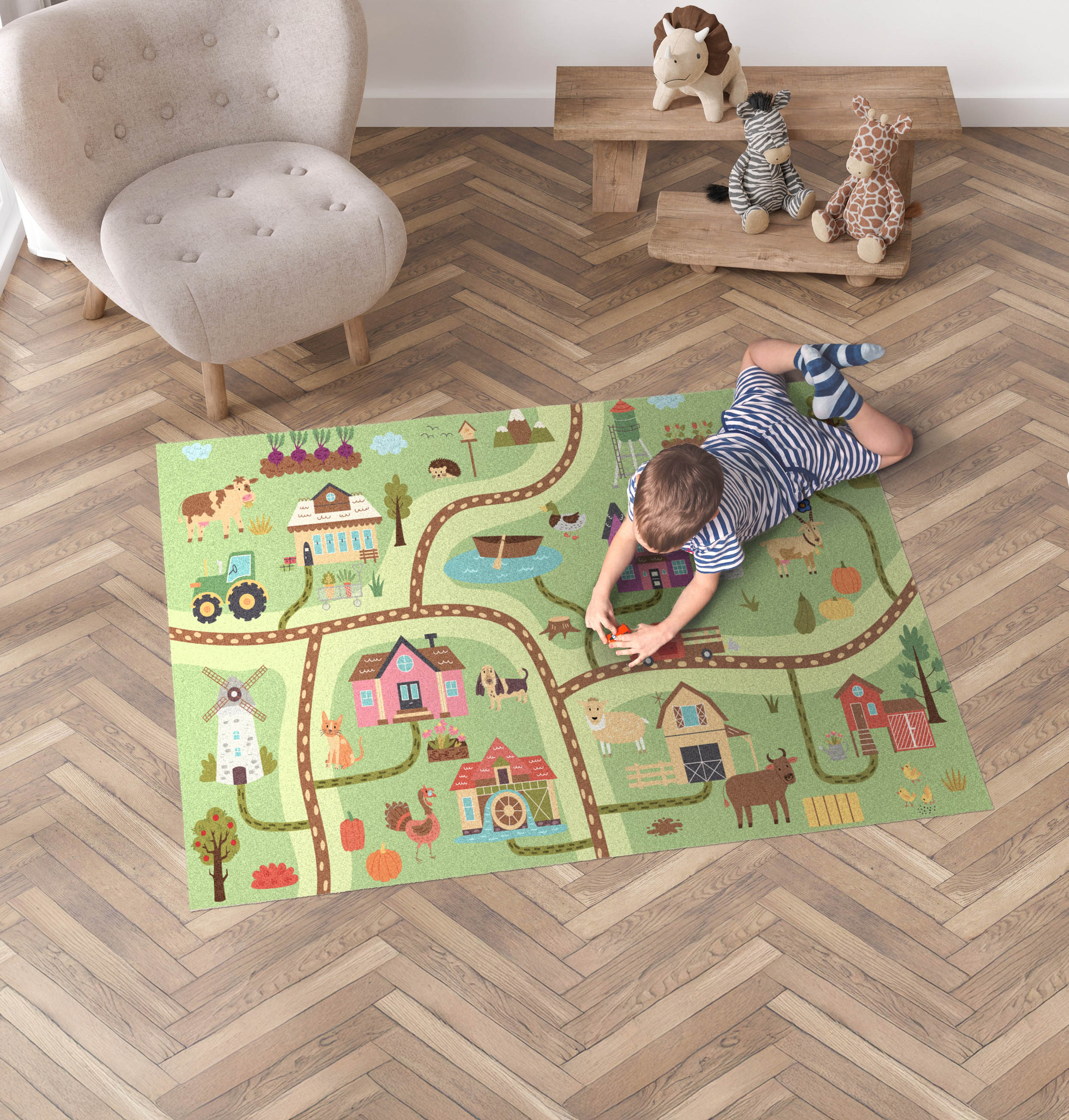 Boy playing with toy cars on a printed road rug