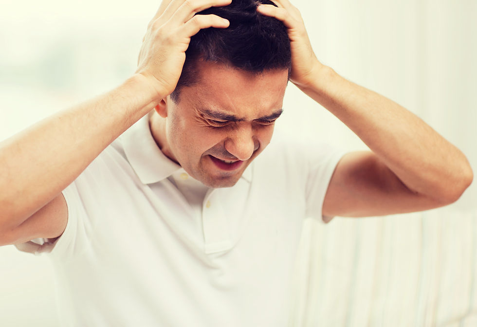 man holding head in frustration