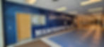 High school athletics wall wrap near gymnasium featuring maverick mascot