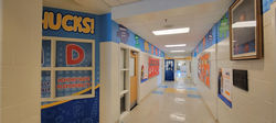 Puzzle piece themed hallway partial wall wrap at elementary school