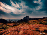 Rocky landscape under dramatic sky, a scenic view of the mountain range.
