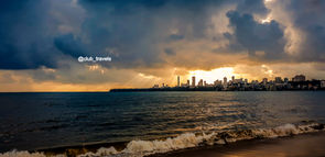 Mumbai skyline at sunset with dramatic sky and ocean view @club_travels