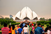 Lotus Temple in Delhi with people nearby and cloudy sky Car Rental In India