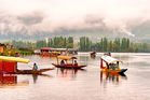 Boats on Dal Lake with mountains in the background. Scenic tourism view.
