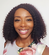 Image of the business owner smiling, wearing a floral dress