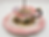 Close-up of a decorative rose-patterned teacup bird feeder filled with mixed wild bird seed
