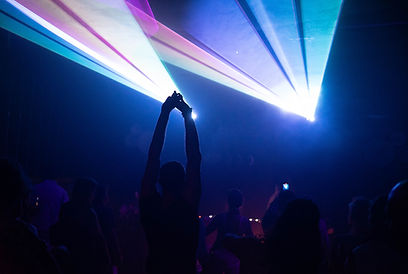 Laser-drenched dancefloor with people moving intentionally, embodying presence and connection through movement.