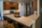 remodeled kitchen with granite countertops and warm wood cabinetry.