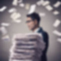 pile of invoices in front of the person.jpg