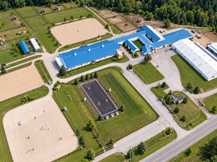Aerial drone view of Royal Canadian Riding Academy (RCRA) equestrian facility and outdoor riding arenas in Cedar Valley, Ontario.