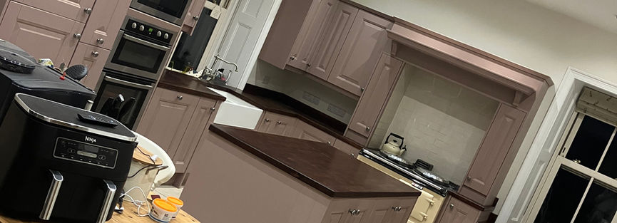 Modern kitchen with purple cabinets and appliances, A4 Decorating Limited.