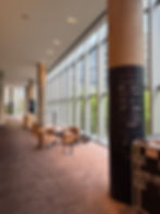 Spacious hallway with pillar wall graphic and seating area