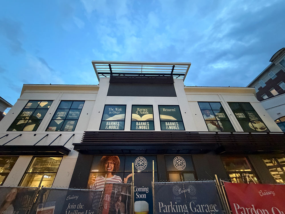 Barnes & Noble store with various window graphics, 'Coming Soon'