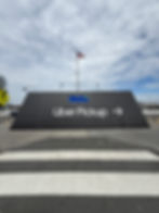 Uber Pickup sign, a large black wall graphic with arrow