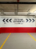 Wall graphics: 'FUTURE RESIDENT PARKING' in a garage