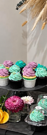 Mint, teal and lavender cupcakes, coordinating cake pops and individually packaged treats displayed by The Cake Studio FoCo.