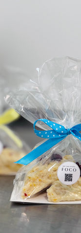 Individually packaged scones tied with blue and yellow ribbons and finished with The Cake Studio FoCo labels.