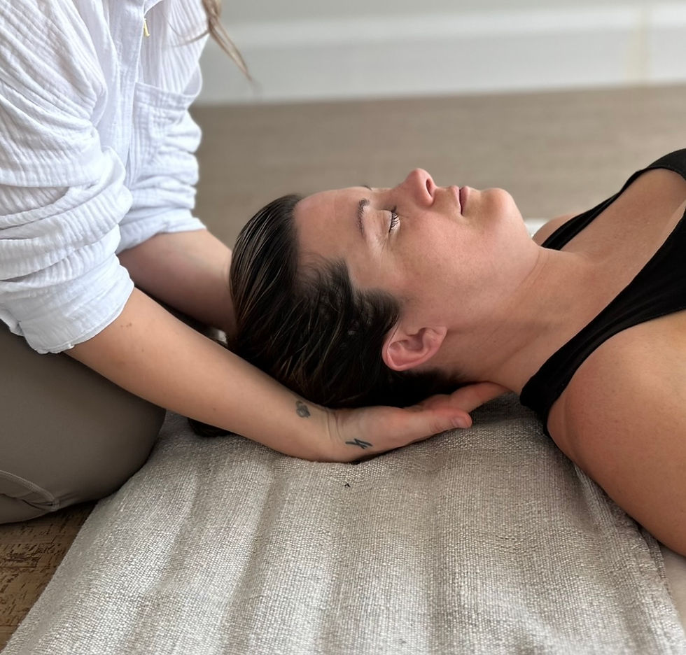 Hannah holding clients head as they lay back and relax into it. Reiki. Compassion. Care.