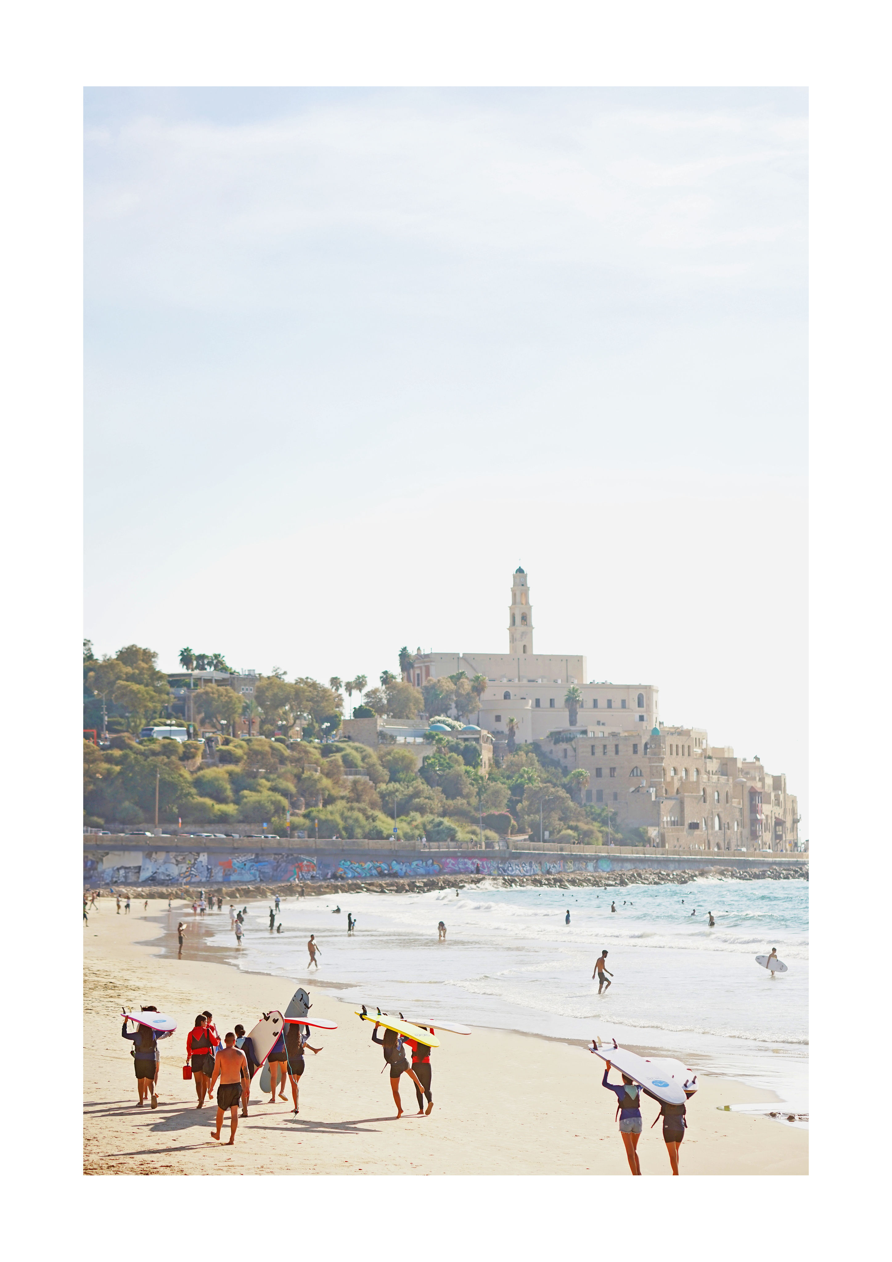 Jaffa beach print - surfers carrying boards with Old Jaffa skyline behind