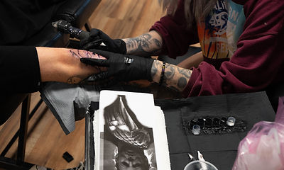 client getting a tattoo from a tattoo artist at the Tattoo Institute of SWFL a tattoo school in Fort Myers Florida