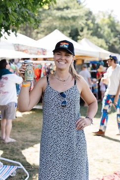 woman holds up JFTP cider