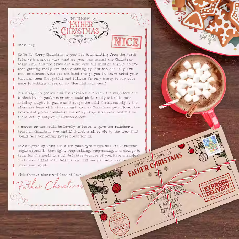 Personalised Father Christmas letter with a NICE list stamp next to a matching kraft envelope tied with red and white twine,