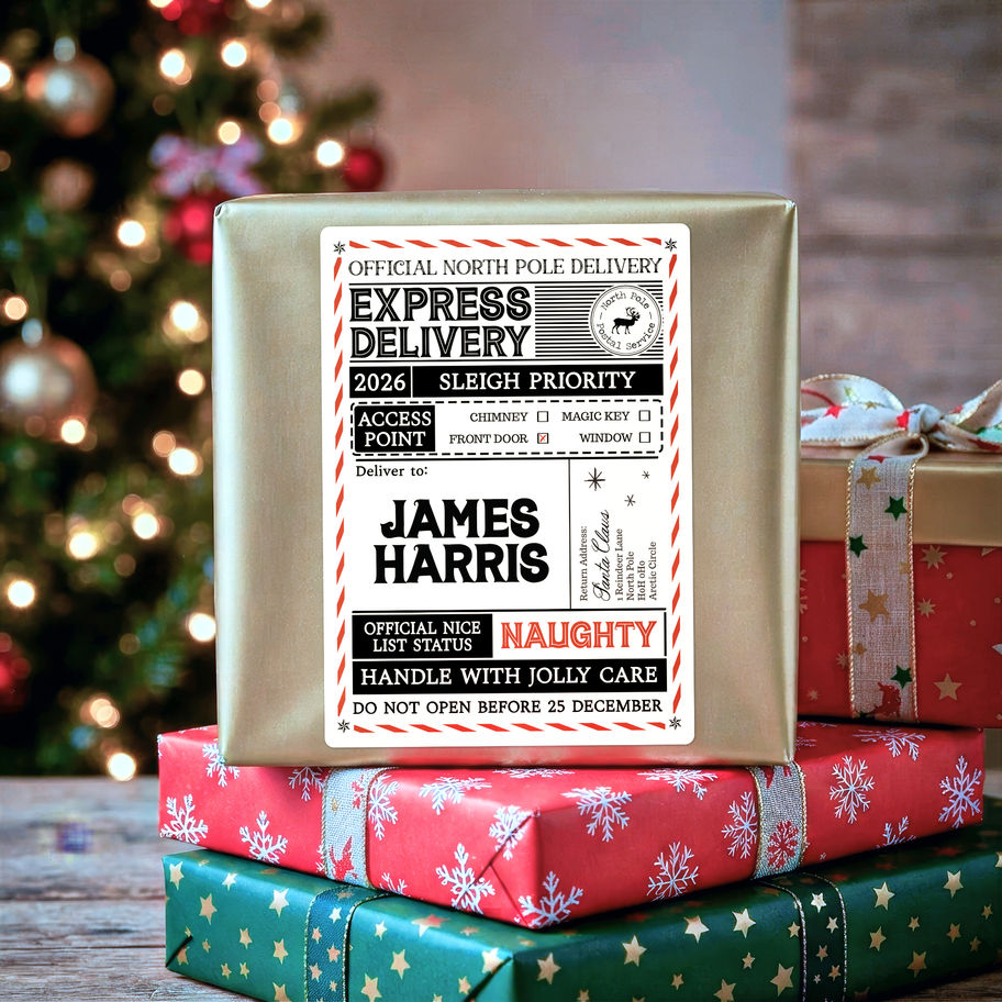 Personalised Santa delivery label on a kraft wrapped parcel with pine cones and cinnamon sticks, marked Nice