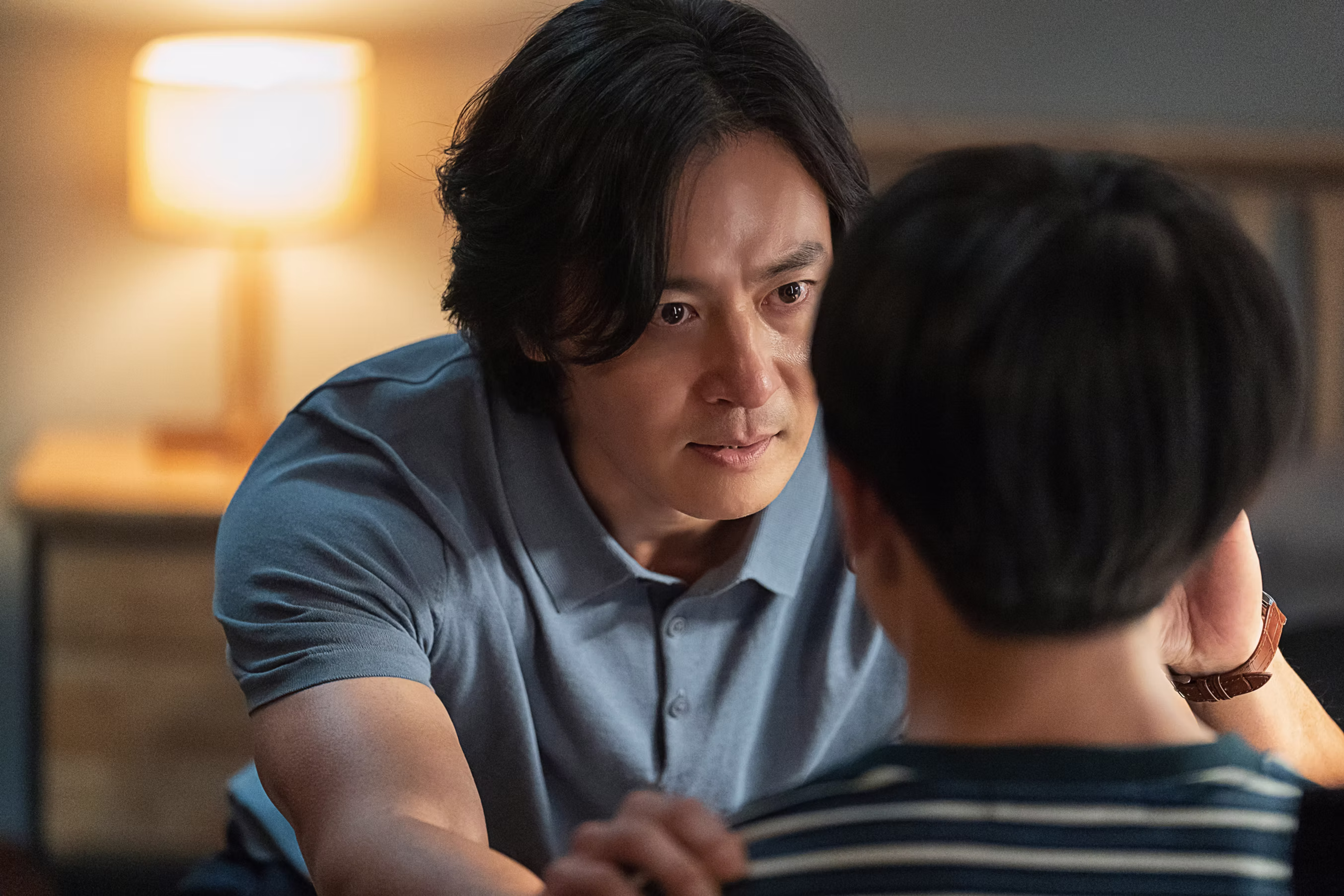 A man looking into his son's eyes and holding him by the shoulders