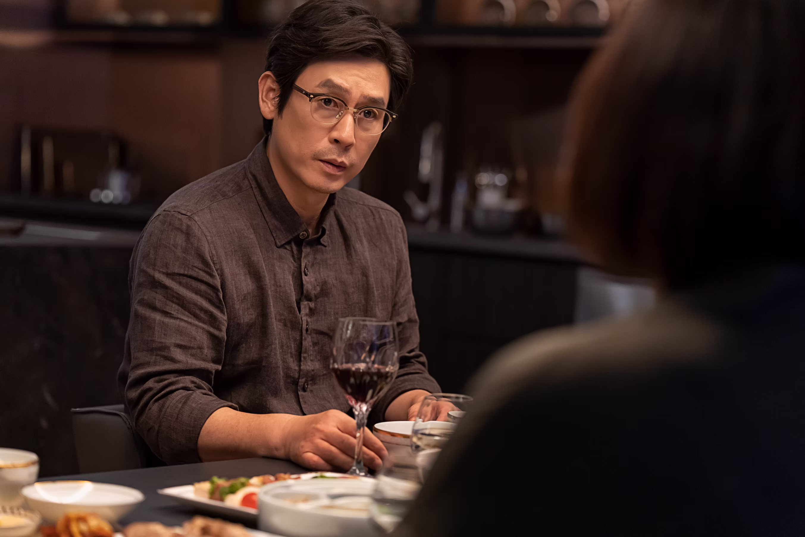 A man at the dinner table looking concerned