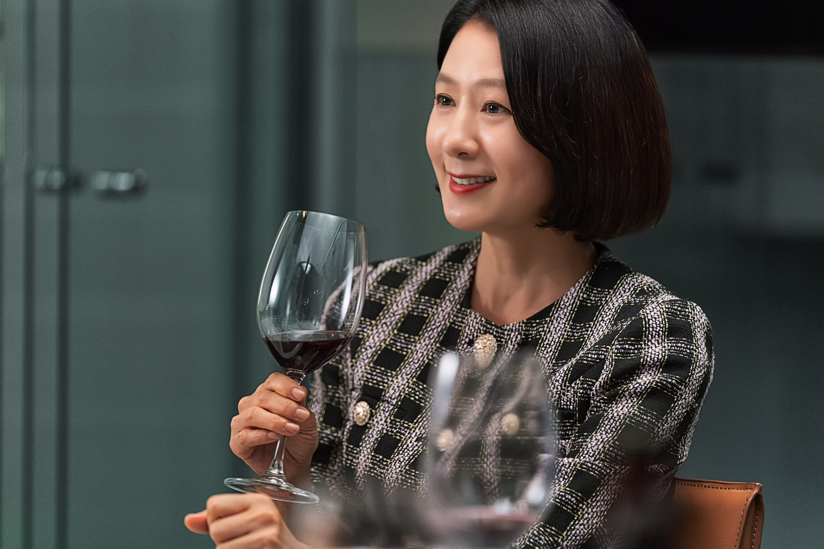 A woman holing a glass of wine