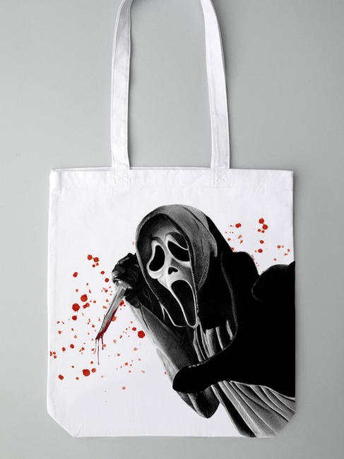 White Tote Bag featuring realism drawing of Ghostface. In the drawing Ghostface is holding up a knife, with blood dripping off and blood platter surrounding it. The background is plain Background is plain