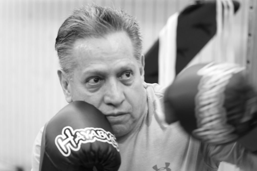 Boxing coach in Santa Ana holding focus mitts during private boxing training session