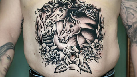 Traditional american tattoo of the pharaoh's horses as a stomach piece