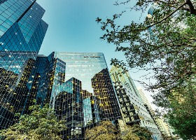 Modern glass skyscrapers under a clear blue sky