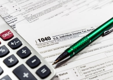 1040 U.S. individual income tax return with calculator and pen