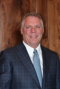 Dr. Charles Dingman in a suit smiling