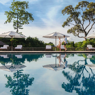 Couple by resort pool; relaxing getaway