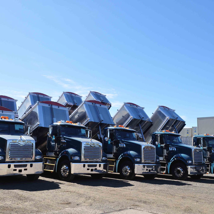 Row of dump trucks with raised beds