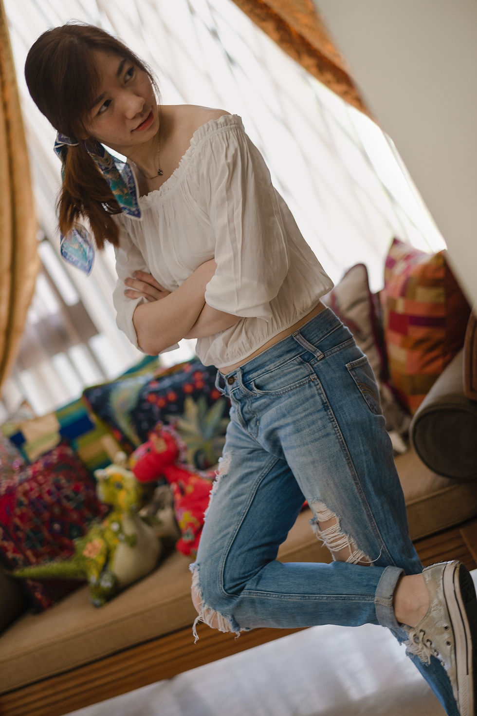 Brandy Melville off-shoulder top, Hollister ripped boyfriend jeans, and Converse sneakers, casual outfit by RollingBear Travels.