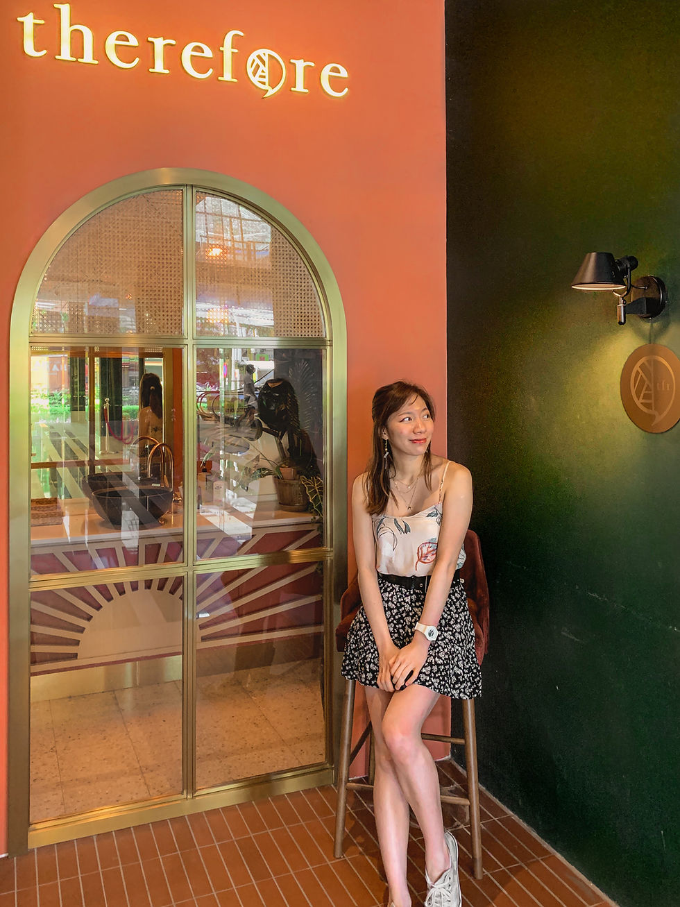 Style blogger in floral camisole and skirt outfit against entrance of Therefore Cafe, Malaysia, RollingBear Travels blog.